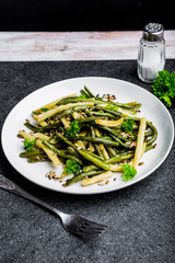 Fried green beans with sunflower seeds and parsley