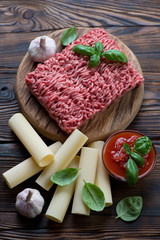 Ingredients for preparing italian cannelloni with minced meat