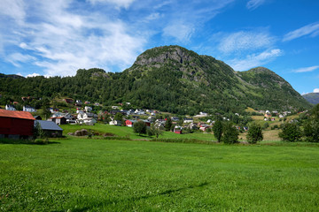 The small norwegian village Roeldal, with red and white wood houses spread out on the mountain slopes, in Hordaland, Norway