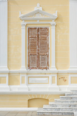 Classic wooden window on creamy wall
