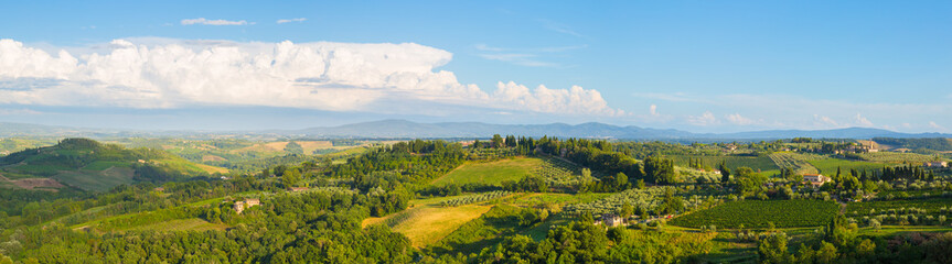 Fototapeta na wymiar Wide panoramic landscape of surroundings of the medieval city of San Giminiano, Tuscany, Italy.