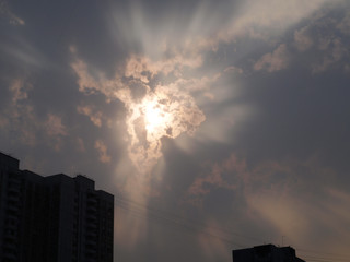 Ray of light through clouds in city