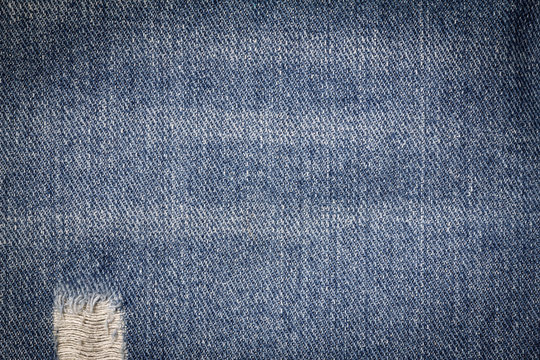 Denim jeans texture or denim jeans background with old torn. Old grunge vintage denim jeans. Stitched texture denim jeans background of jeans fashion design.