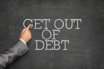 Get out of Debt text on blackboard with businessman hand pointing