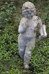 Anciant sculpture of a boy in Dion, Greece.
Stone statue of a child in City of Dion, Macedonia, Greece.