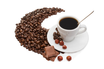 cup of coffee with cinnamon sticks, anise and chocolate