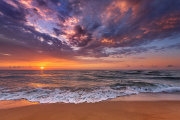 Naklejka na ściany i meble Beautiful tropical sunrise on the beach.
