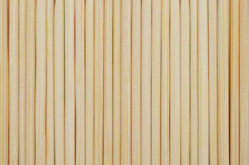 Vertical bamboo toothpicks line up in row