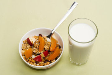 muesli with peach, apple and a glass of milk 