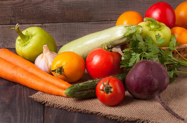 harvest of vegetables on a wooden background