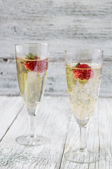 two champagne glasses and strawberries