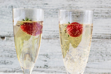 two champagne glasses and strawberries