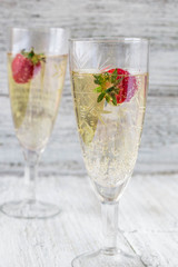 two champagne glasses and strawberries
