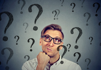 Thoughtful confused handsome man has many questions no answer