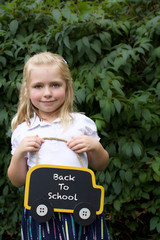 young girl child holding sign back to school