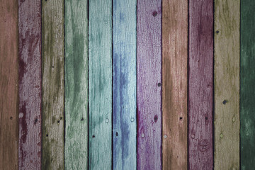 Rainbow color painted old weathered wooden boards background.