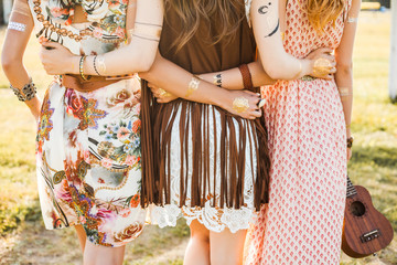 Three cute beautiful hippie girl in the setting sun, outdoors, the best of friends hugging and...