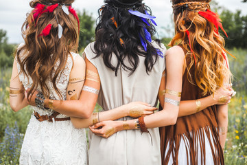 Three beautiful cheerful hippie girls, best friends, the outdoors, cute smile, trendy hairstyles,...