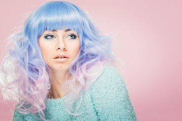 Gorgeous young woman with pastel blue and pink hair. Fashion model with colorful hair
