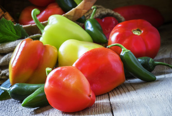 Bell pepper, tomatoes and chili peppers on old wooden style, rus