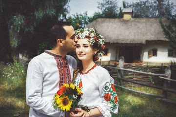 young Ukrainian couple in traditional clothes