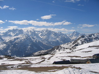 Fototapeta na wymiar View from the top of the Col du Granon mountain pass towards the mountains above Serre Chevalier, France on a sunny day in early Spring