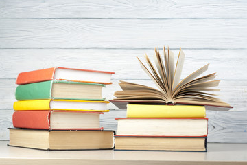 Open book, hardback books on wooden table. Education background. Back to school. Copy space for text.