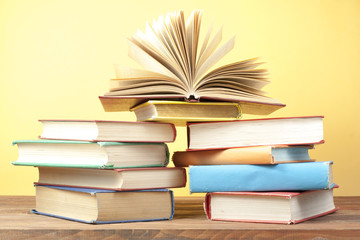 Open book, hardback books on wooden table. Education background. Back to school. Copy space for text.