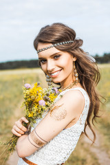 Pretty amazing gentle young hippie girl on the nature in the open air, the feathers in her hair,...