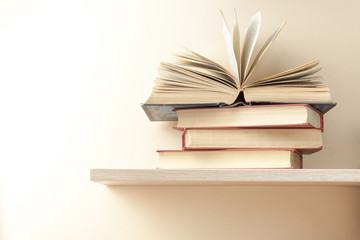 Open book, hardback books on wooden table. Education background. Back to school. Copy space for text.