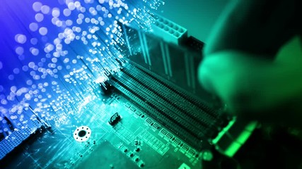 Technician's hands installing user memory on a computer main-board