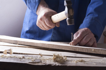 Carpenter working with plane on wooden background at Building Site. Joiner workplace