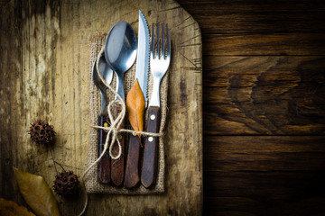 Autumn Halloween composition. Rustic set of cutlery knife, spoon, fork.