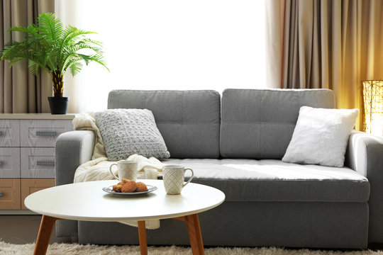 Living room design interior with sofa and round table