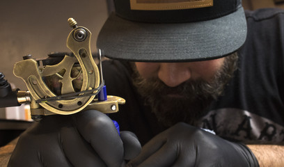 Tattoo artist tattooing