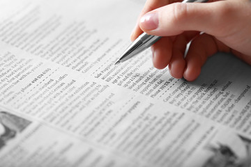 Obraz premium Search newspaper advertisements for information