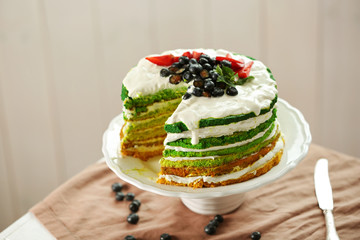 Delicious cake with berries on stand