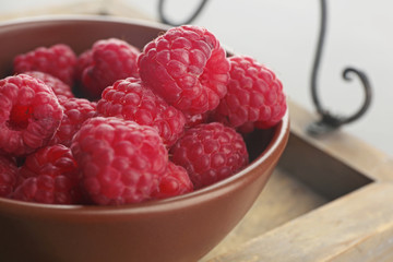 Fresh raspberry in bowl, closeup
