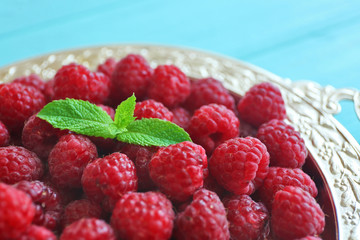Fresh raspberry with mint leaf, closeup