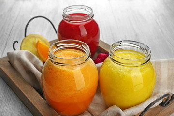 Fruit and berry cocktails on wooden tray