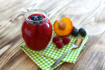 Fresh fruit and berry cocktail on wooden background