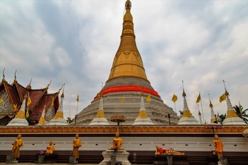 Gold pagoda  and blue sky background.,Wat Chumphon Khiri temple, Mae Sot, Tak province, Thailand
