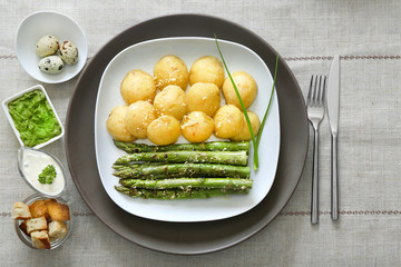 Grilled asparagus with potatoes on plate