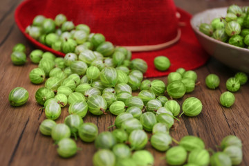 Gooseberries with hat on table