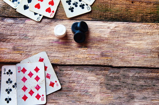 Cards and chips on old wooden background