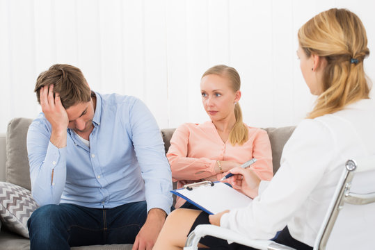 Psychologist Sitting With Frustrated Couple