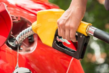 Businesswoman's Hand Refueling Car's Tank