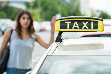 Woman Calling For Taxi On Street