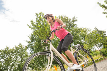 Fototapeta na wymiar Happy Female Cyclist Riding Bicycle