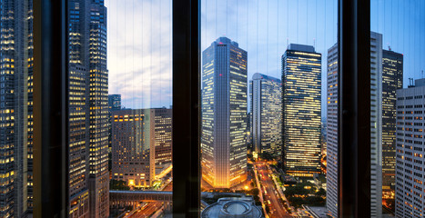 modern office buildings in tokyo through window